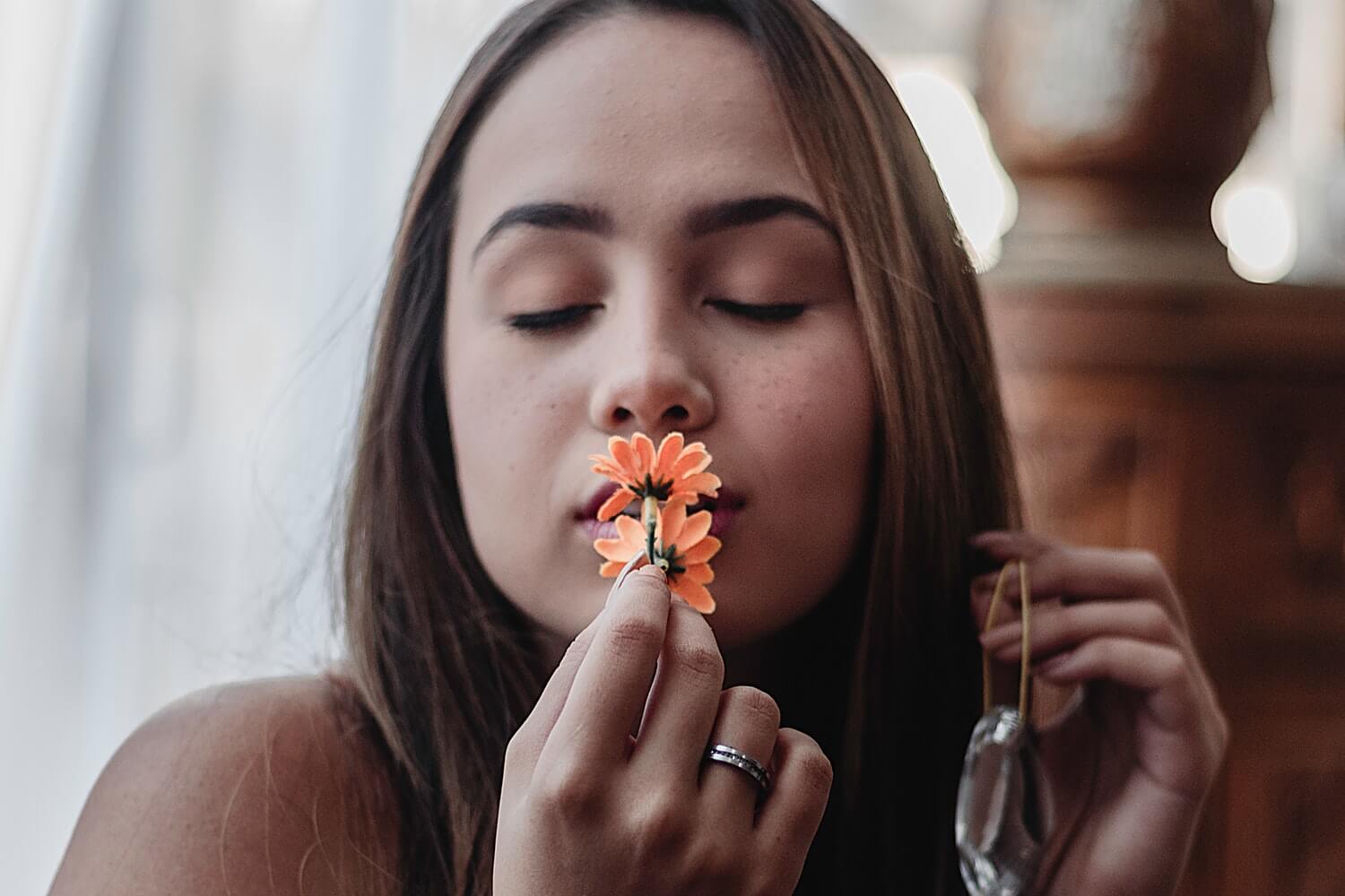 woman-smelling-flower